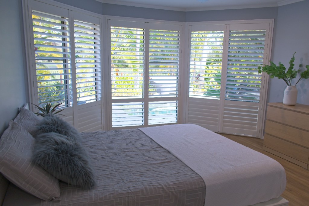 Custom plantation shutters installed in a bedroom